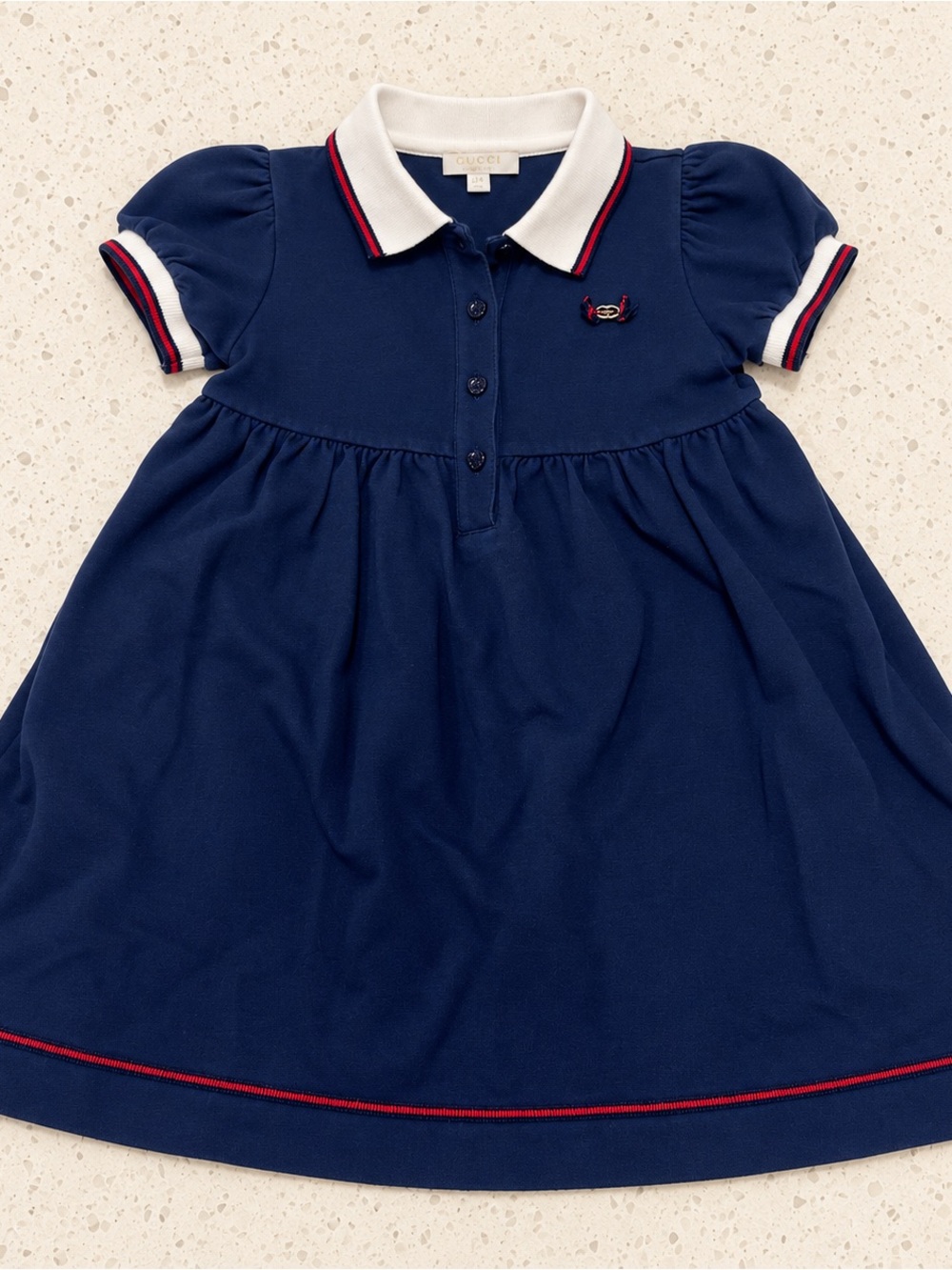 Gucci baby girls’ navy polo dress, tagged size 18–24 months. Made in Italy.